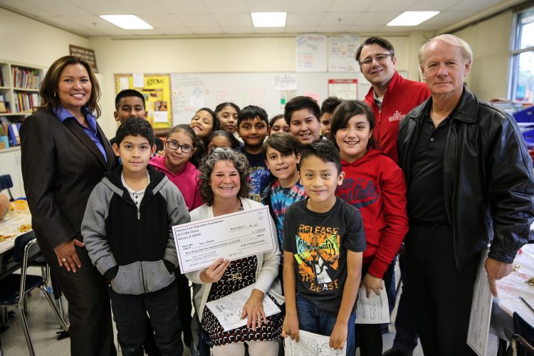 Gates principal Nitza Carrillo joins Sue-Z Bruno and her class during a mini grant presentation from AEEF's chair Bill Deligiannis and member Bill Suhayda.