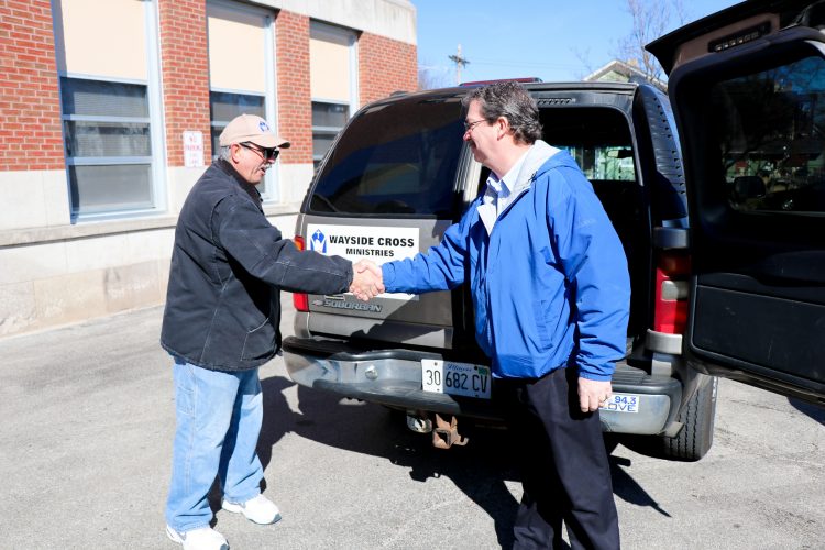 George Bavas (left) from Wayside Cross Ministries greets Sodexo's Simon Seibert as he picks up recovered food from East Aurora School District 131.