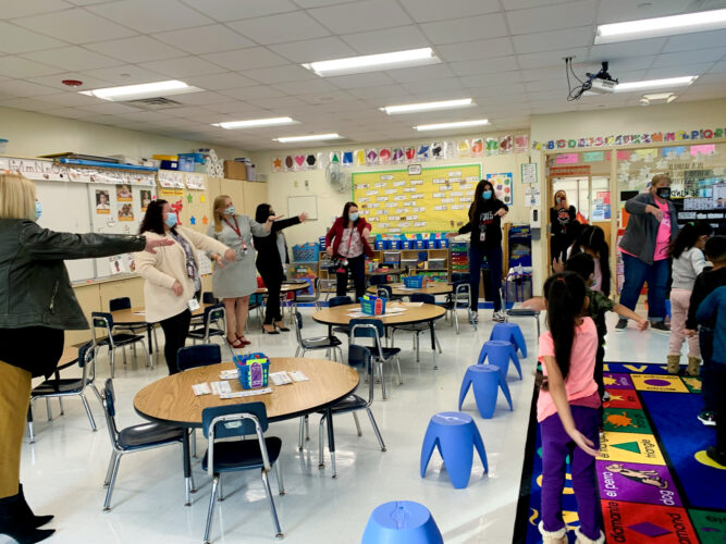 Dr. Mercuri joins a lesson teaching 5's and 10's using total physical response.