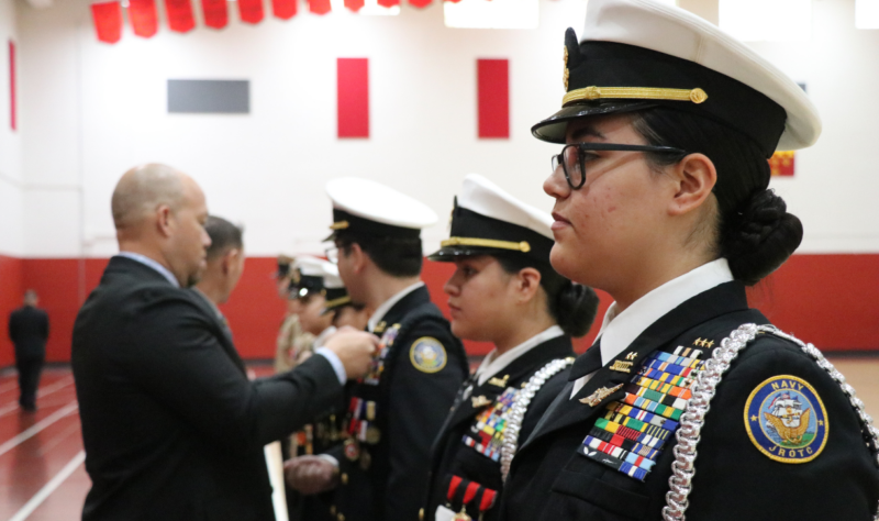 EAHS Principal Jerry Cook and Mr. Rampa awarding Cadets with their FAA Drone pilots wings.