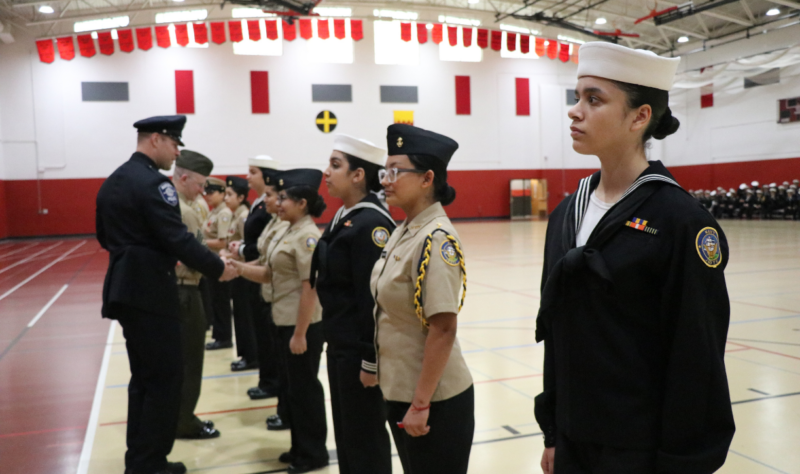 Officer Woolsey, EAHS (Campus Resource officer) and GySgt Mihovilovich, USMCR EAHS (Social Studies teacher) present individual Cadet awards.