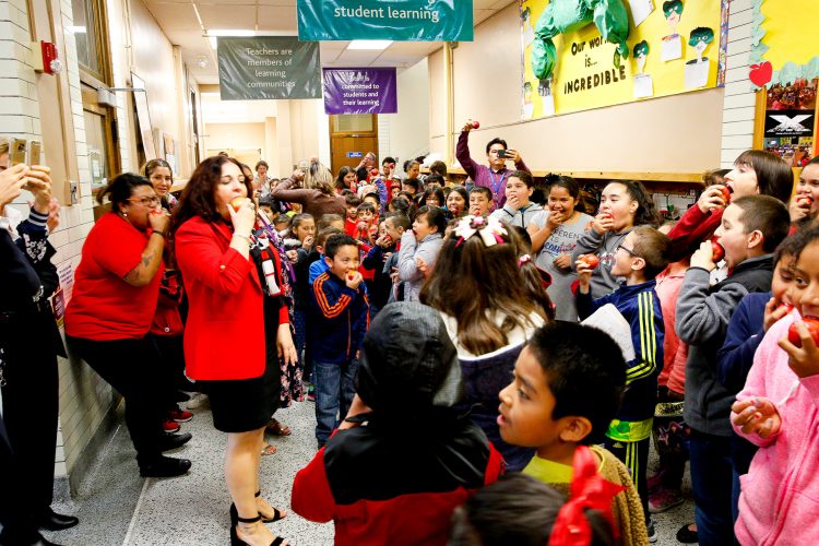 Crunch! One million students across the Midwest bite into an apple.