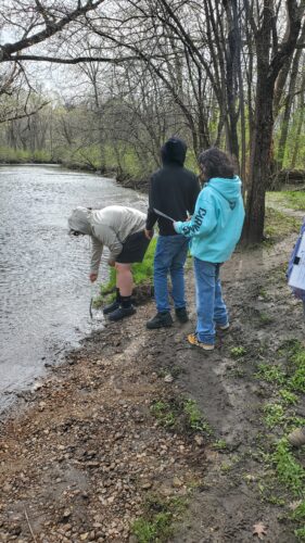 Students test the temperature of Ferson Creek.