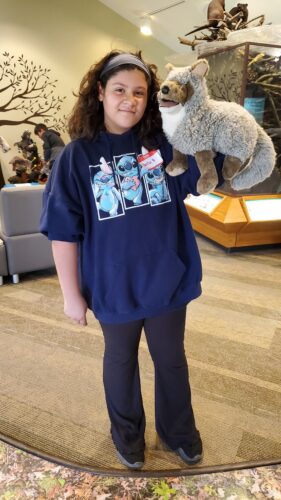 A student shows off some native Illinois species in puppet form.
