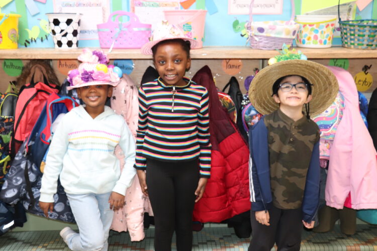 Students pose in the hallway with their Spring hats.