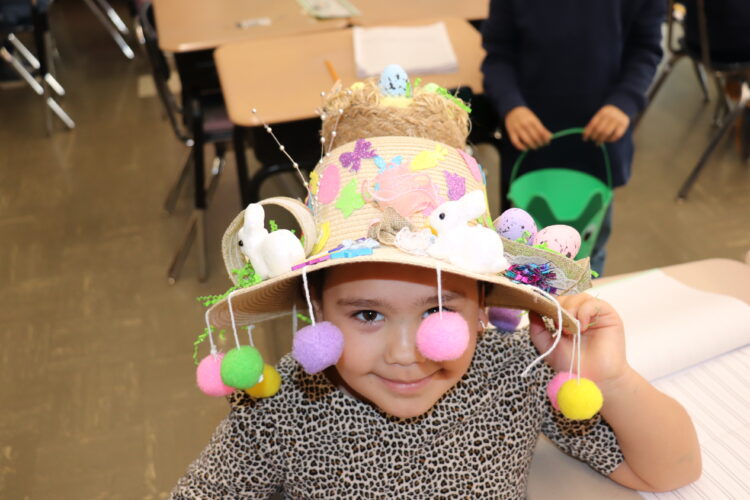 A student shows off their Spring hat.