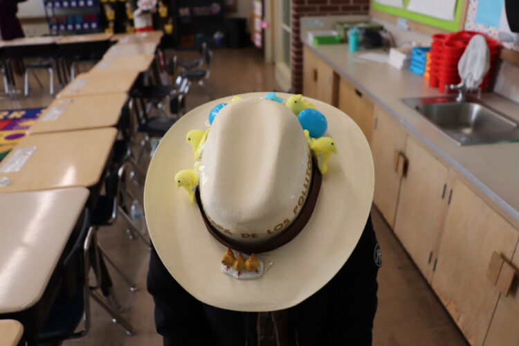 A student shows off their Spring hat.
