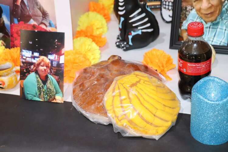 Photos and memories of loved ones adorn the Hermes ofrenda.