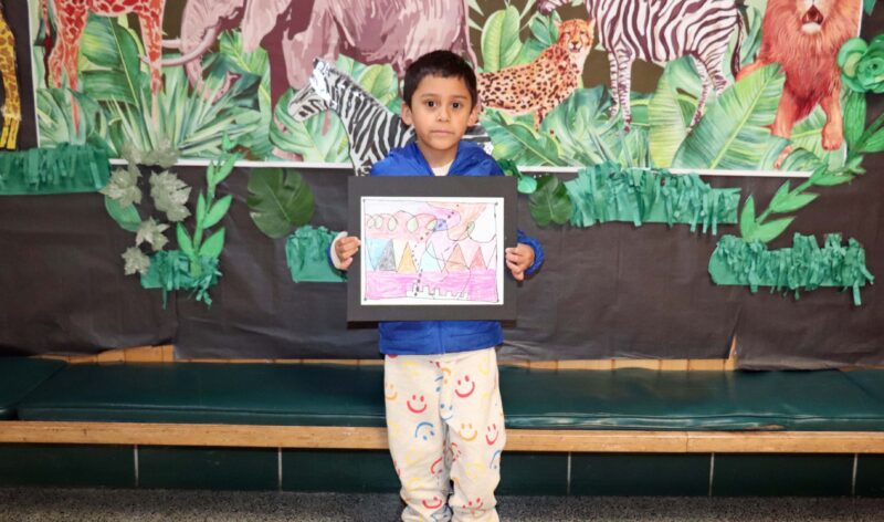 Javier, a 1st grader, shows off his artwork entitled, "Lines".