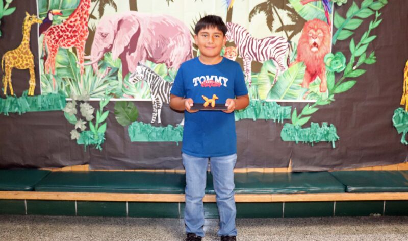 Oscar, a 5th grader, shows off his artwork entitled, "Balloon Animal".