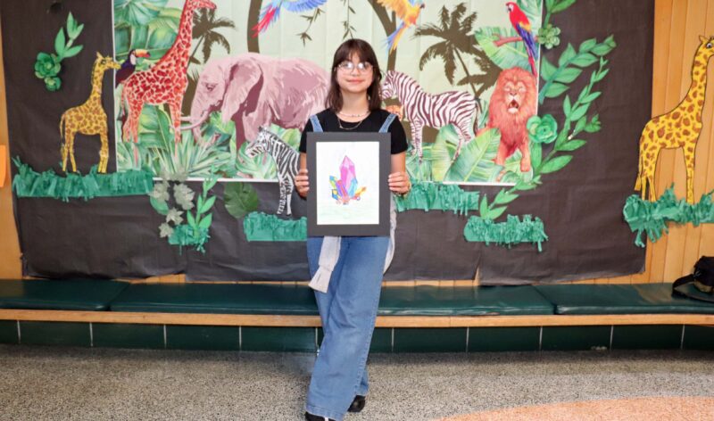 Natalia, a 5th grader, shows off her artwork entitled, "Crystals".