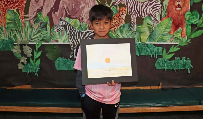 David, a 4th grader, shows off his artwork entitled, "The Beach".