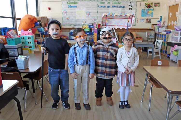 Kindergarten students show off their 100th day outfits.
