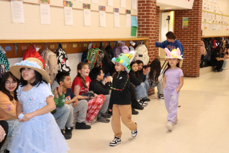 1st Graders parade down the hallway to show off their Spring hats.