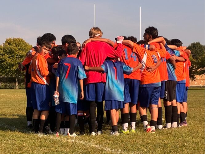 Soccer players huddling before the start of their game